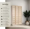 A light wood bookshelf filled with empty compartments, next to a potted plant. Produktbild-Vorschau
