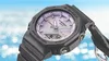 A close-up of a G-Shock watch with a colorful dial, set against a blurred background of blue sky and white clouds. Anteprima dell’immagine prodotto