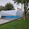 A covered swimming pool in a backyard setting. Produktbild-Vorschau