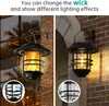 Two solar-powered wall lanterns are shown, one with a flickering flame effect and the other with a standard bulb, mounted on brick walls. Produktbild-Vorschau