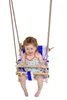 A baby sitting in a swing. Produktbild-Vorschau