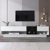 A modern living room setup with a TV mounted on a wall above a white and black media console. Produktbild-Vorschau