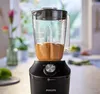 A close-up of a black Philips blender with a partially filled pitcher of an orange-colored smoothie. Podgląd zdjęcia produktu