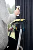A person is using a cleaning tool on a ladder, with a bucket and cleaning supplies. Podgląd zdjęcia produktu