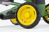 Close-up of the wheels and frame of a green and yellow pedal go-kart. Podgląd zdjęcia produktu