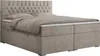 A beige boxspring bed with a tufted headboard and two pillows, shown from a side-angle. Produktbild-Vorschau