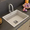 A modern kitchen sink with a beige faucet and a bowl of figs on the countertop. Anteprima dell’immagine prodotto