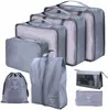 A collection of grey packing cubes and bags arranged in a visually appealing manner. Podgląd zdjęcia produktu