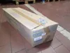 A cardboard box is placed on a tiled floor in what appears to be a warehouse or storage area. Anteprima dell’immagine prodotto