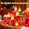 A table setting with Christmas decorations, including red gift boxes and LED candles. Produktbild-Vorschau