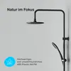 A black shower system with a rain shower head and a hand shower, mounted on a light gray wall. Text overlays highlight features and branding. Produktbild-Vorschau