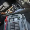 A car's interior with a jump starter kit connected. Produktbild-Vorschau