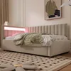 A bedroom scene featuring a beige upholstered bed with integrated LED lighting. Náhled obrázku produktu