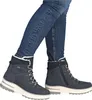 A person wearing blue jeans and blue winter boots. Produktbild-Vorschau