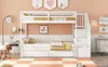 A white bunk bed with a pull-out trundle bed is set up in a child's room with peach walls. The room is decorated with simple artwork and a floor lamp. Podgląd zdjęcia produktu