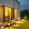 Solar garden lights illuminating a modern house and lawn at dusk. Produktbild-Vorschau