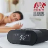A woman sleeping in bed with a digital radio alarm clock in the foreground. Náhľad obrázku produktu