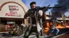A chaotic scene with people in combat, explosions, and a tank in front of a "Fast Forward" store. Produktbild-Vorschau