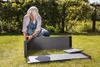 A woman assembling a raised garden bed in a grassy yard. Náhľad obrázku produktu