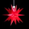 A red star-shaped decoration hangs against a black background. Produktbild-Vorschau