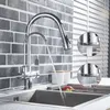 A kitchen faucet with a pull-out spray head is shown in use, with water flowing into a sink. Insets show close-ups of the faucet's spray functions. Náhľad obrázku produktu