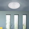 A ceiling lamp with a starry sky effect is mounted on a light blue ceiling above three tall windows with blinds. Produktbild-Vorschau
