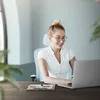A woman is working on a laptop in an office environment. Náhľad obrázku produktu