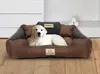 A golden retriever puppy lies on a brown and gray dog bed. Voir les images du produit