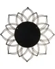The back of a decorative wall mirror with a flower-like metal frame. Náhled obrázku produktu
