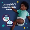 A baby wearing Pampers pants lying on a dark blue surface with stars. Produktbild-Vorschau