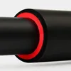 A close-up view of a black bar with a red and black foam grip. Voir les images du produit