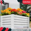 A white wooden planter box filled with colorful flowers, placed outdoors. Produktbild-Vorschau