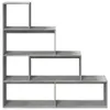 A multi-level, modular bookshelf with a concrete gray finish, presented against a white background. Náhled obrázku produktu