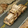A wooden model of a heavy truck is placed on a road with rocks and sand on the sides. Náhľad obrázku produktu