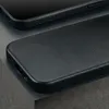 A close-up shot of a black leather phone case with the brand name embossed on it. Anteprima dell’immagine prodotto