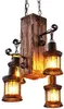 A rustic chandelier with a wooden beam and four lantern-style lights. Náhled obrázku produktu