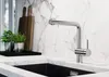 A modern kitchen sink area with a chrome faucet and marble countertops. Produktbild-Vorschau