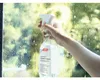 A hand sprays a cleaning liquid onto a window with water droplets. Náhled obrázku produktu