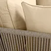 A close-up view of a sofa's cushions and woven frame. Produktbild-Vorschau