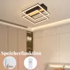 A modern ceiling light fixture with square frames, illuminated by LED lights, shown in a bedroom setting with built-in wardrobes. Voir les images du produit