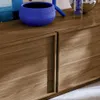A close-up view of a wooden cabinet with two doors and a blue decorative bowl on top. Anteprima dell’immagine prodotto
