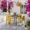 An outdoor patio with a dining set, decorated with bougainvillea flowers. Anteprima dell’immagine prodotto