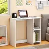 A white desk with a laptop, clock, and books is set up in a room with a window and a bed in the background. Anteprima dell’immagine prodotto
