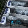Solar step lights are shown on outdoor stairs during heavy rain. Produktbild-Vorschau