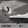 Close-up of vinyl flooring being installed, showing the adhesive backing and the wood-grain texture. Podgląd zdjęcia produktu