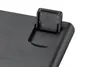 A close-up view of a black plastic flip-up stand on a black surface, likely a keyboard. Produktbild-Vorschau