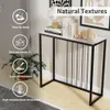 A console table with books and decorative items on top, set against a wall with artwork. Produktbild-Vorschau
