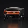 A black pizza oven with glowing orange interior, set against a dark background. Produktbild-Vorschau