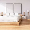 A bedroom scene with a bed, pillows, and bedside tables. Produktbild-Vorschau