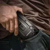 A person is putting a phone case into their jeans pocket. Produktbild-Vorschau